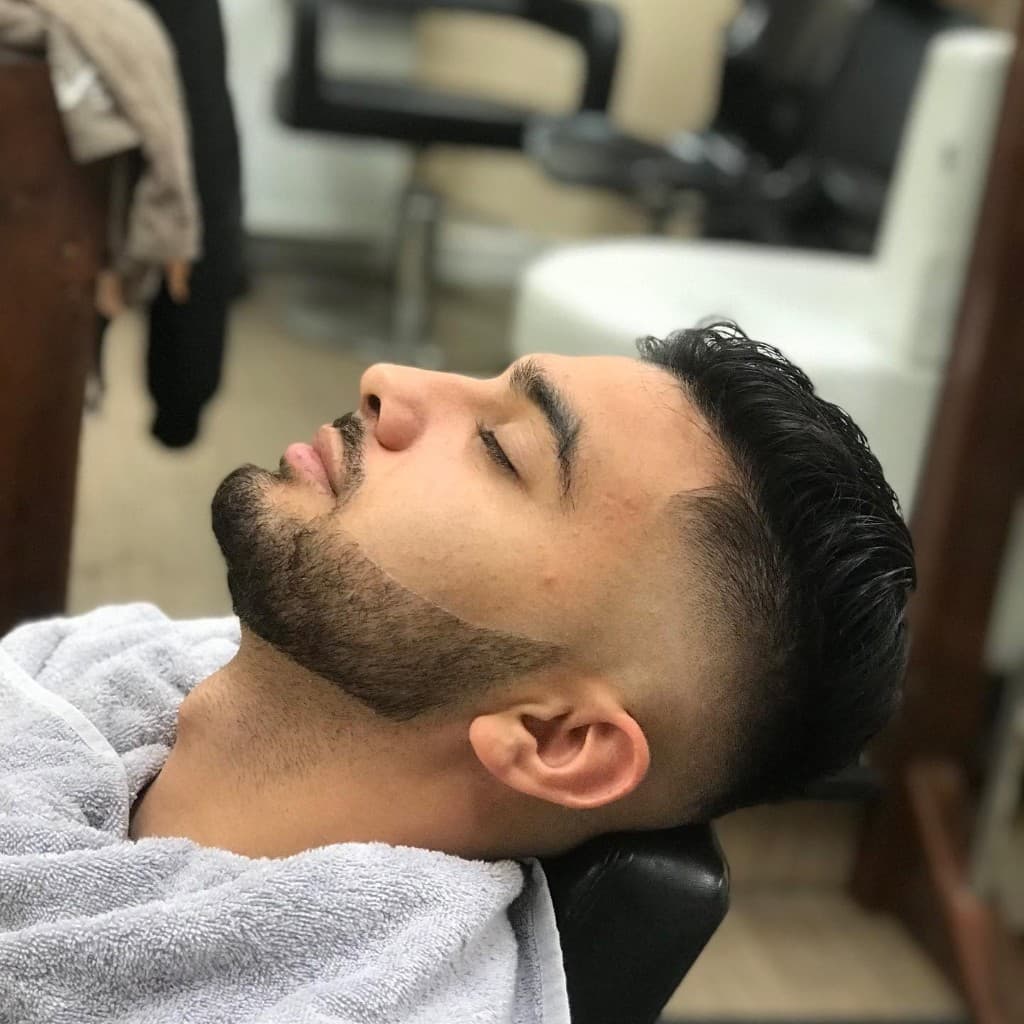 Skin fade and precise beard shape finished in the chair