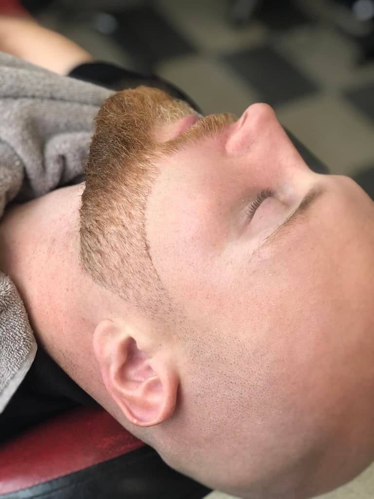 Sharp ginger beard lineup on a clean shaved head